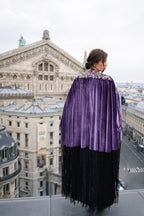 Person wearing a purple cape with a cityscape in the background. Opera coat. Eid look. Eid outfit. Ramadan outfit